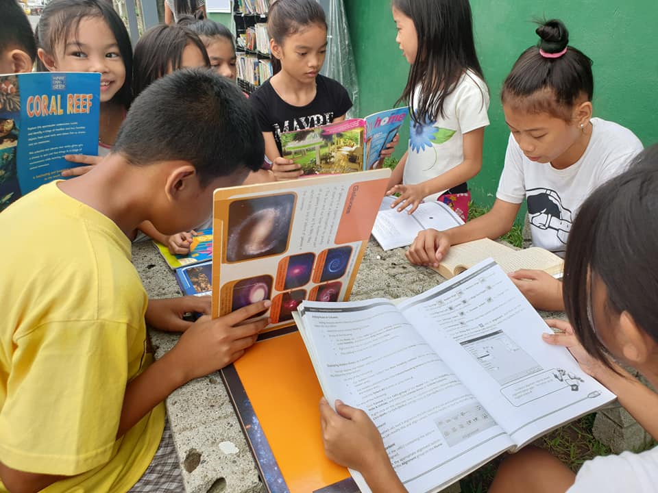 Children reading books at the Street Library in Davao